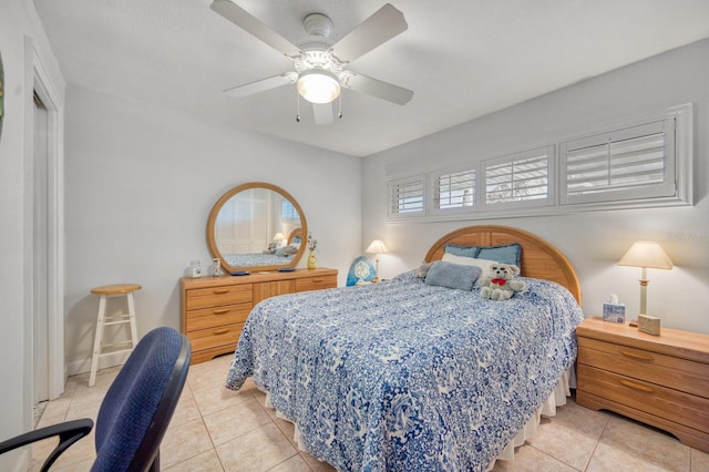 tiled bedroom with ceiling fan