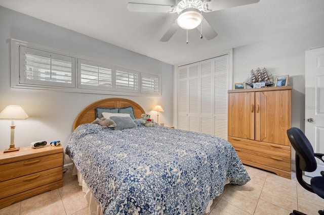 bedroom with light tile patterned floors, a closet, and ceiling fan