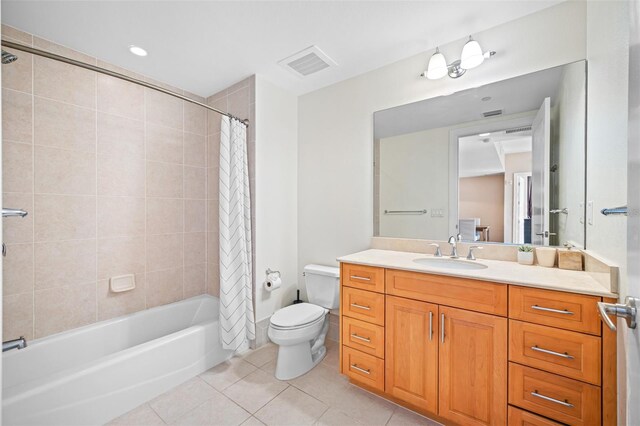 full bathroom featuring toilet, large vanity, tile floors, and shower / bathtub combination with curtain