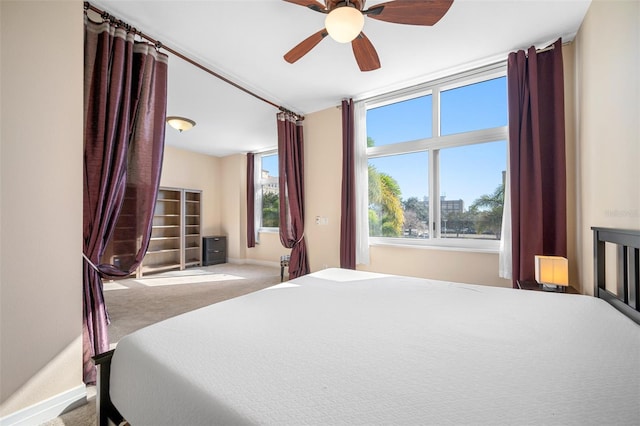 bedroom featuring light colored carpet and ceiling fan