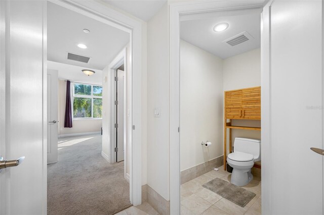 bathroom featuring toilet and tile flooring