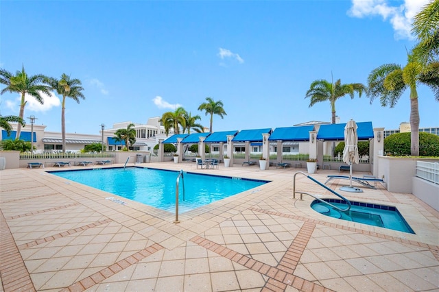 view of swimming pool with a community hot tub and a patio