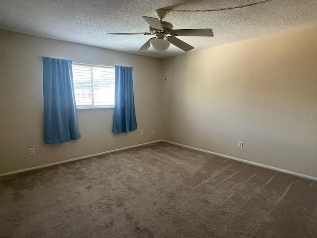 carpeted empty room with ceiling fan and a textured ceiling