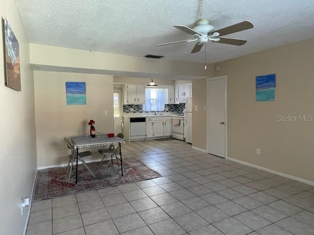 kitchen featuring white cabinetry, tasteful backsplash, light tile patterned floors, ceiling fan, and white appliances