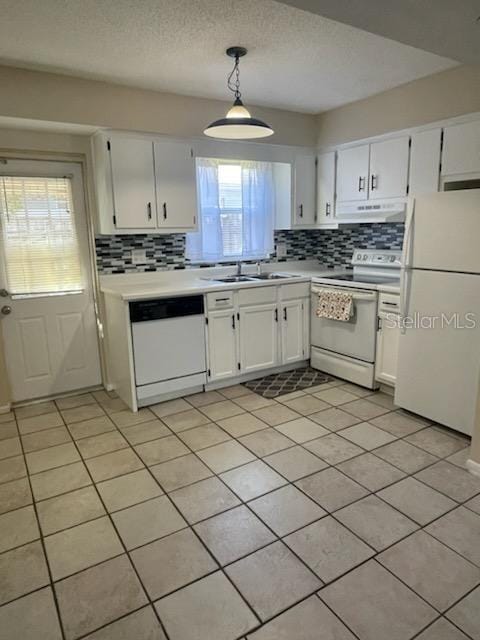 kitchen featuring pendant lighting, white appliances, tasteful backsplash, and white cabinets