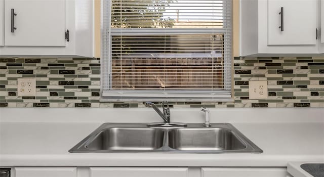 kitchen with white cabinetry, sink, and decorative backsplash