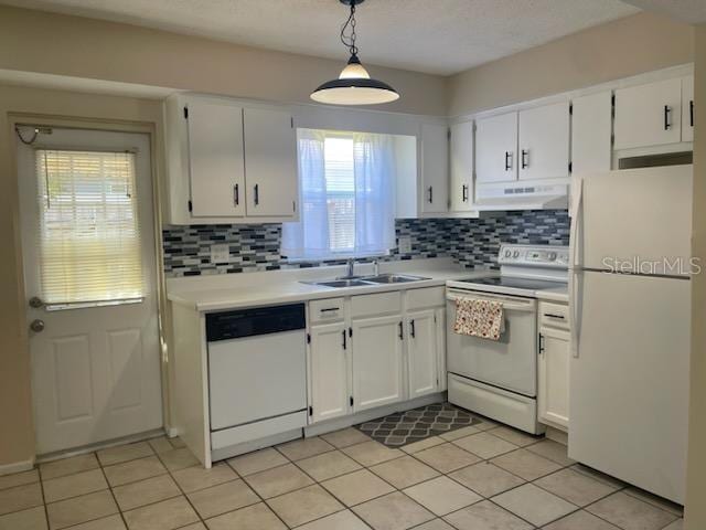 kitchen with pendant lighting, white appliances, and white cabinets