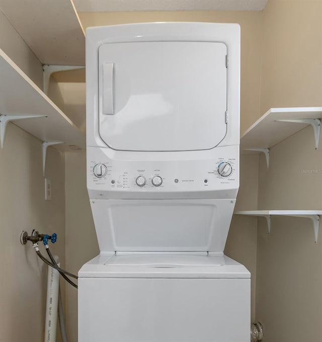 laundry room with stacked washing maching and dryer