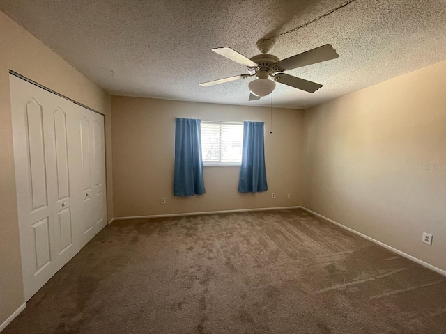 unfurnished bedroom with ceiling fan, a closet, a textured ceiling, and carpet