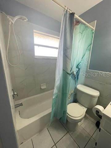 full bathroom featuring vanity, shower / tub combo, tile patterned floors, and toilet