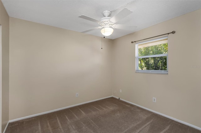 carpeted empty room with ceiling fan and a textured ceiling