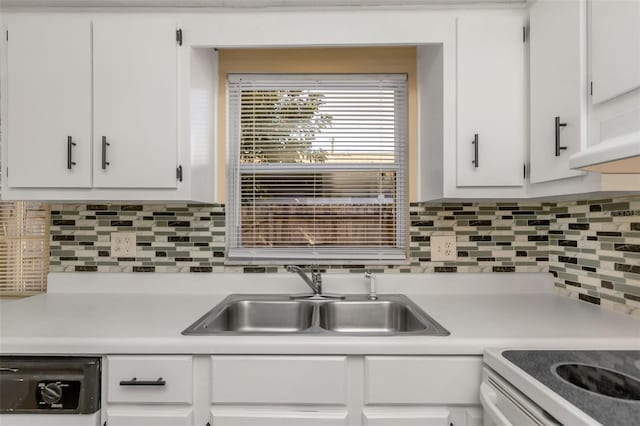 kitchen with dishwasher, white cabinetry, and sink