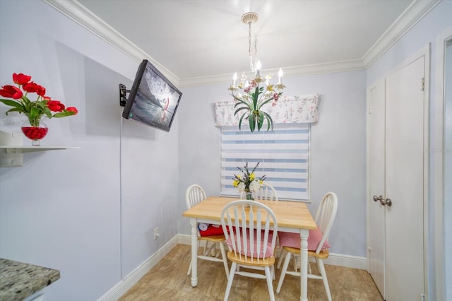 dining room with a chandelier and ornamental molding