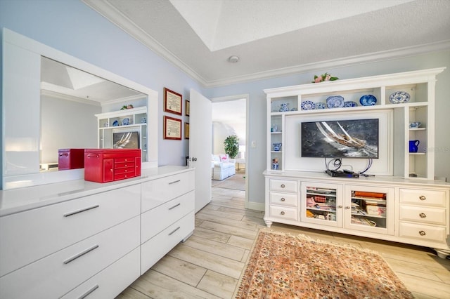 interior space with a textured ceiling, light hardwood / wood-style floors, and ornamental molding