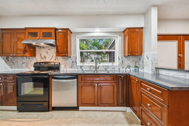 kitchen featuring stainless steel dishwasher, sink, dark stone counters, and black / electric stove