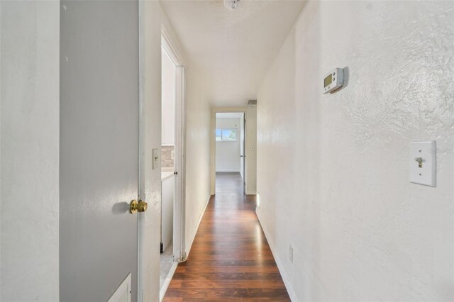 hall with dark wood-type flooring