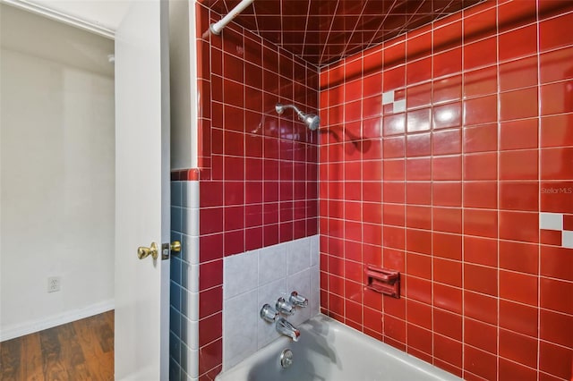 bathroom featuring hardwood / wood-style floors and tiled shower / bath