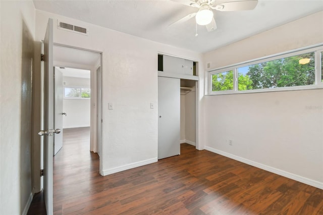 unfurnished bedroom with a closet, ceiling fan, and dark hardwood / wood-style flooring