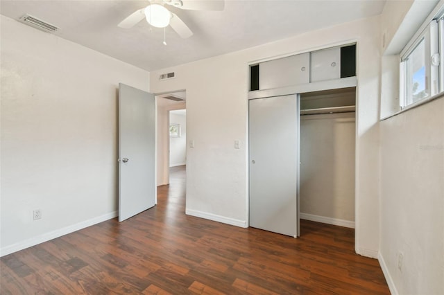 unfurnished bedroom with a closet, ceiling fan, and dark wood-type flooring