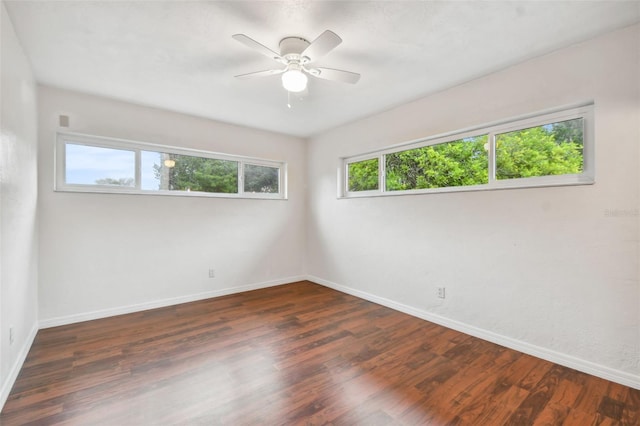 spare room with ceiling fan and dark hardwood / wood-style floors