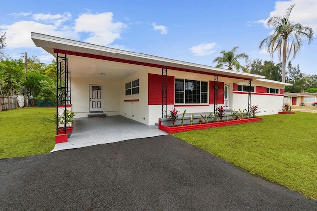 view of front of house with a front lawn and a carport