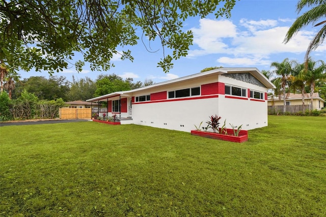 view of side of property with a yard