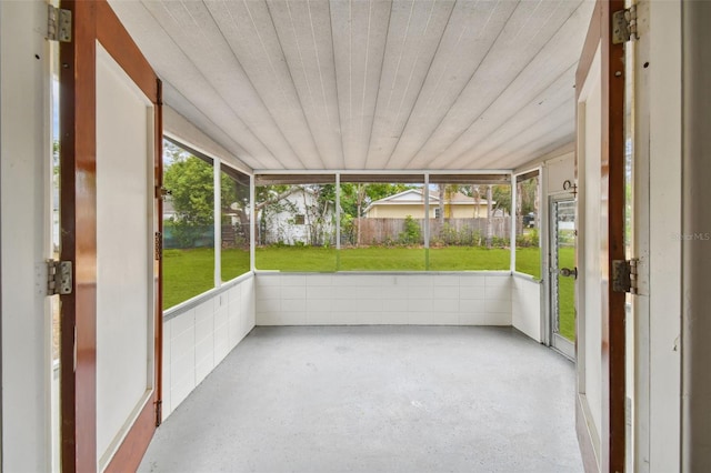 unfurnished sunroom with wood ceiling