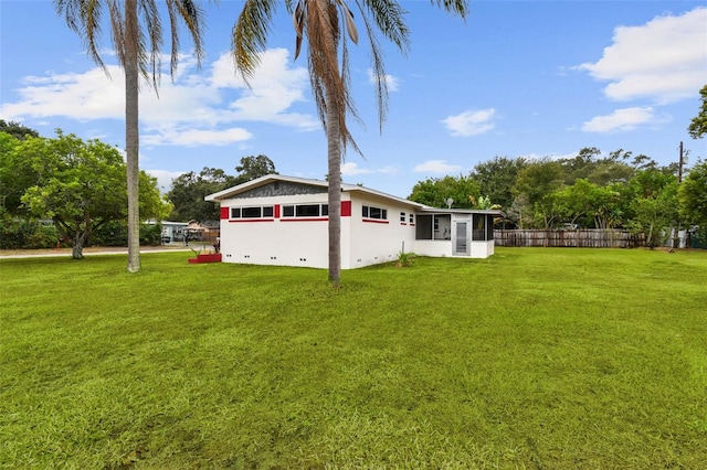 rear view of property with a lawn