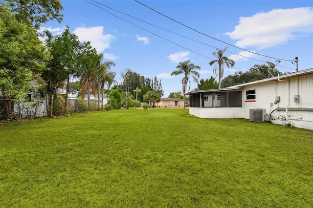 view of yard featuring central AC and a sunroom