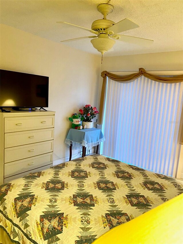 bedroom featuring a textured ceiling and a ceiling fan