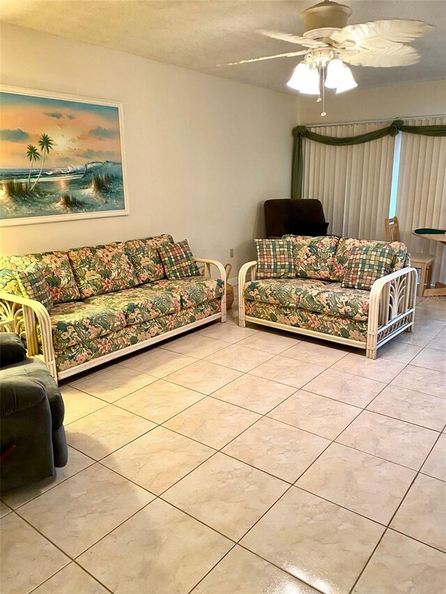 living area featuring a ceiling fan and tile patterned floors