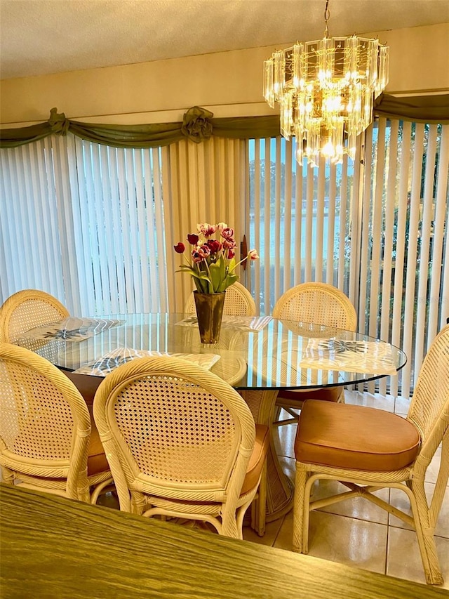 tiled dining room featuring a notable chandelier