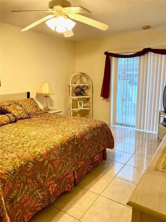 bedroom featuring a ceiling fan, a textured ceiling, and light tile patterned floors