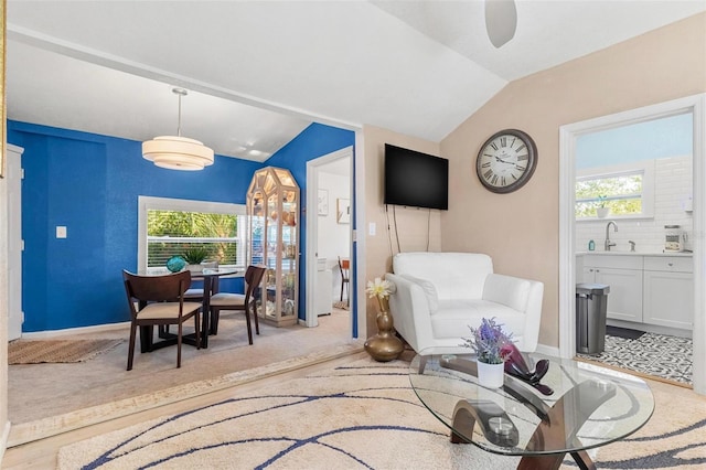 interior space featuring vaulted ceiling and baseboards