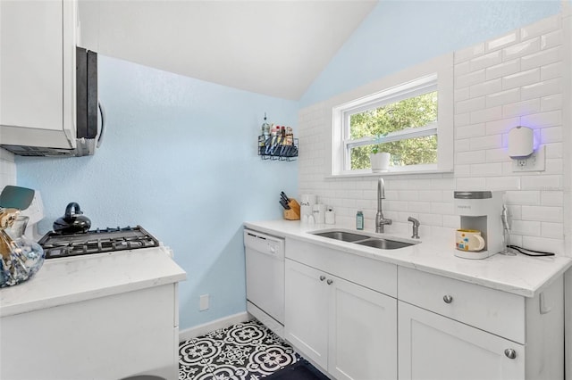 kitchen featuring a sink, white cabinetry, vaulted ceiling, backsplash, and dishwasher