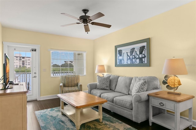 living room featuring dark hardwood / wood-style floors and ceiling fan