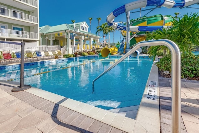 view of pool with a water slide