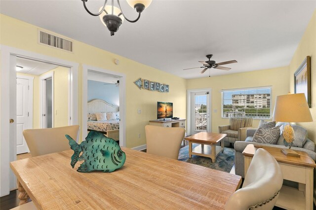 dining space featuring hardwood / wood-style floors and an inviting chandelier