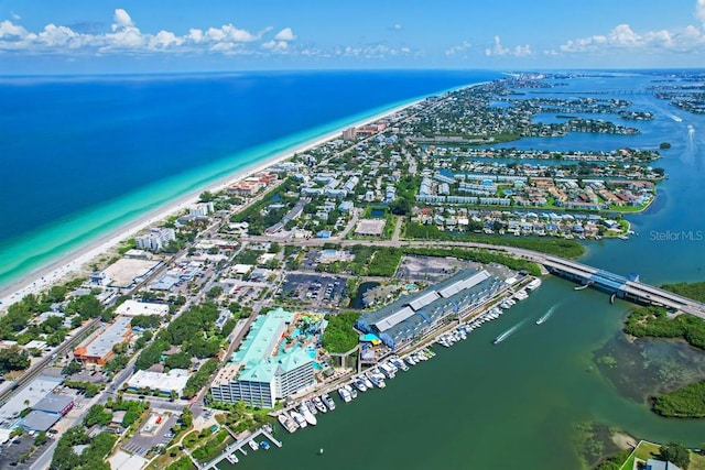 drone / aerial view featuring a water view and a beach view