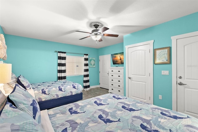 bedroom with a ceiling fan and baseboards