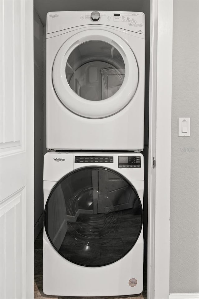 clothes washing area with stacked washer / drying machine