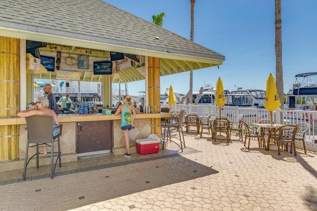 view of play area featuring a bar, a patio area, fence, and a gazebo