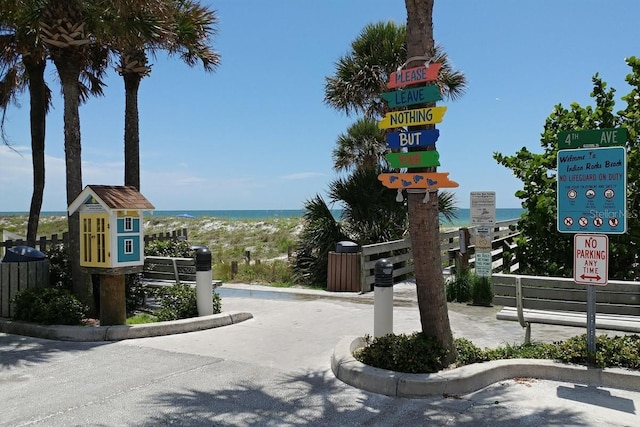 view of road featuring a water view and curbs