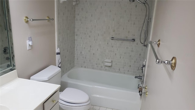 full bathroom featuring tile floors, tiled shower / bath, toilet, and vanity