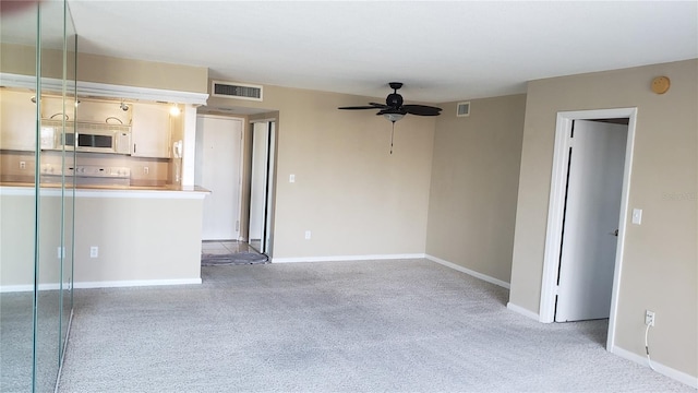 interior space featuring ceiling fan and light colored carpet