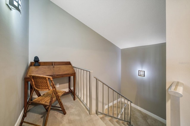 stairs featuring carpet flooring and vaulted ceiling