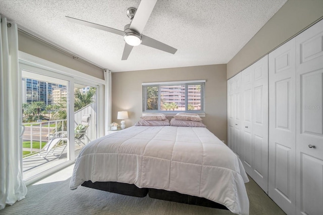 carpeted bedroom featuring access to exterior, a textured ceiling, a closet, and ceiling fan