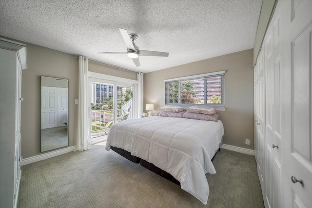 bedroom with multiple windows, ceiling fan, carpet, and a textured ceiling