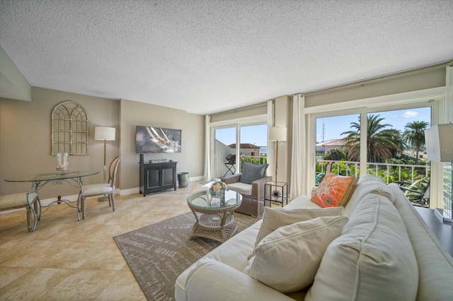 tiled living room featuring a textured ceiling