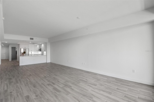 unfurnished living room with light hardwood / wood-style flooring